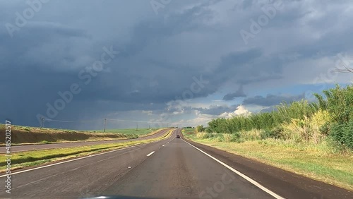 Video time lapse of a car in point of view, through the roads of the rural area of Paraná, Brazil. photo