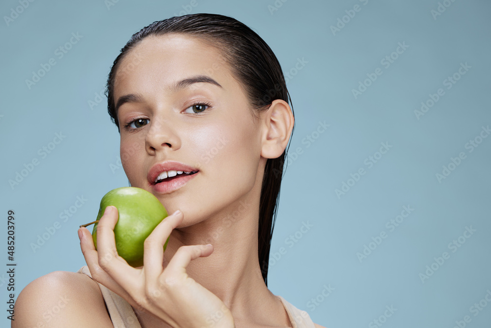 woman with a green apple smile close-up Lifestyle woman with a green apple smile close-up Lifestyle