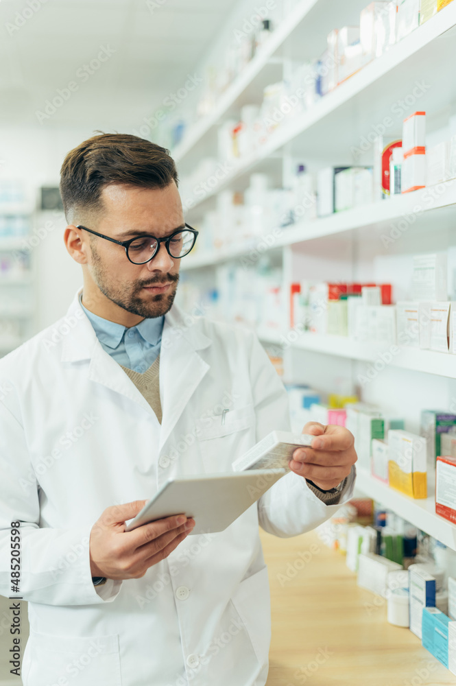 Portrait of a handsome pharmacist working in a pharmacy