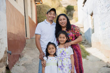 Hispanic family outside their house - Guatemalan family in the alley of their neighborhood
