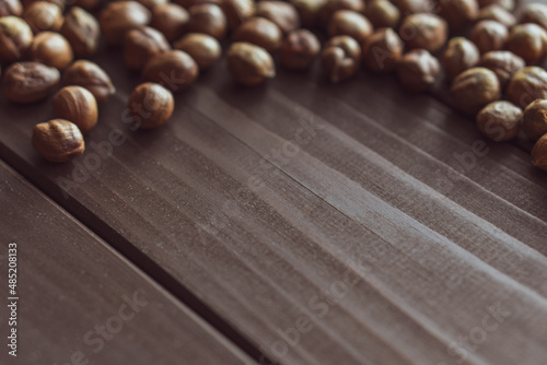 Close up brown hazel nut on wooden desk. Healthy organic vegetarian snack hazelnut. Place for text