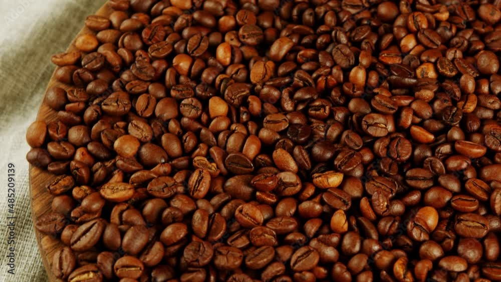 Lots of coffee beans on wooden board. Roasted beans for preparation of fragrant drink. Lots of coffee beans on wooden board. Roasted beans for preparation of fragrant drink.