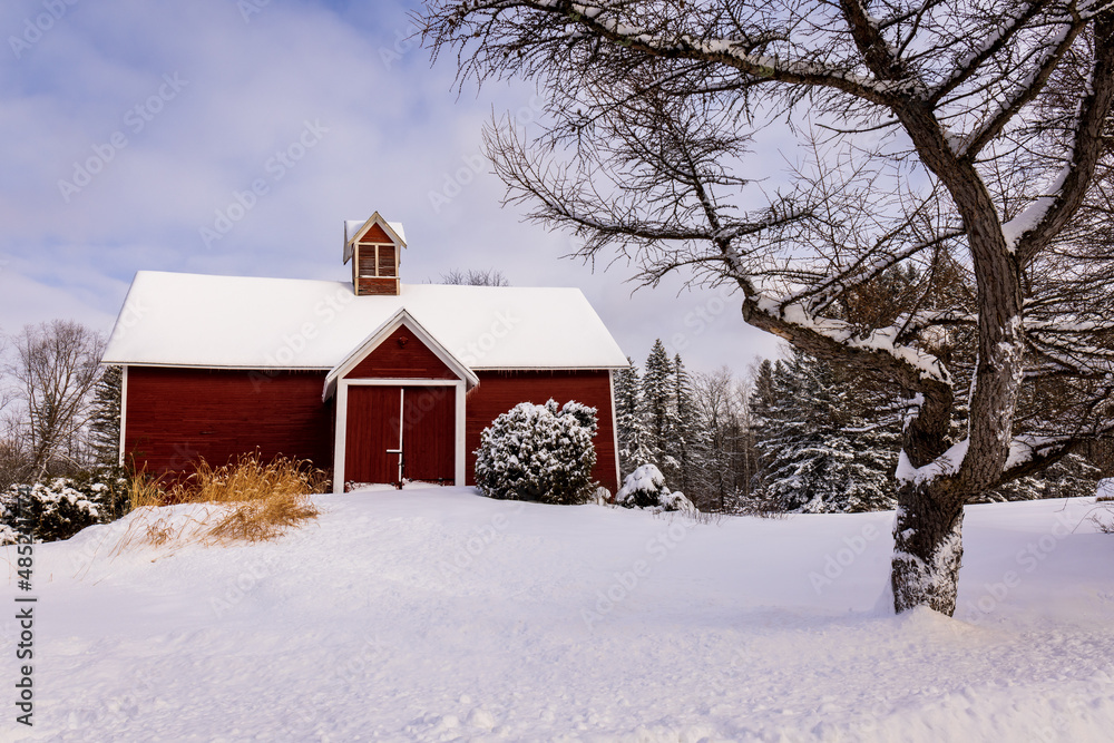 The village of Stanbrige-East, in the Eastern Townships, an old wooden barn painted red, with the land covered with snow. The village of Stanbrige-East, in the Eastern Townships, an old wooden barn painted red, with the land covered with snow.