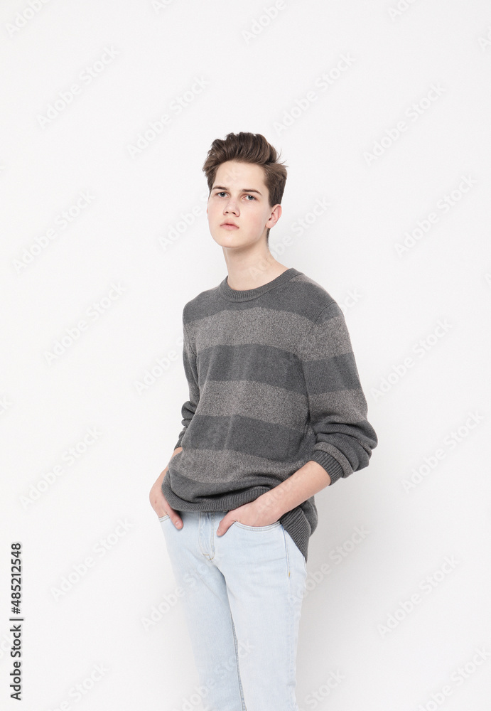 young handsome teenage hipster guy posing against white background isolated young handsome teenage hipster guy posing against white background isolated