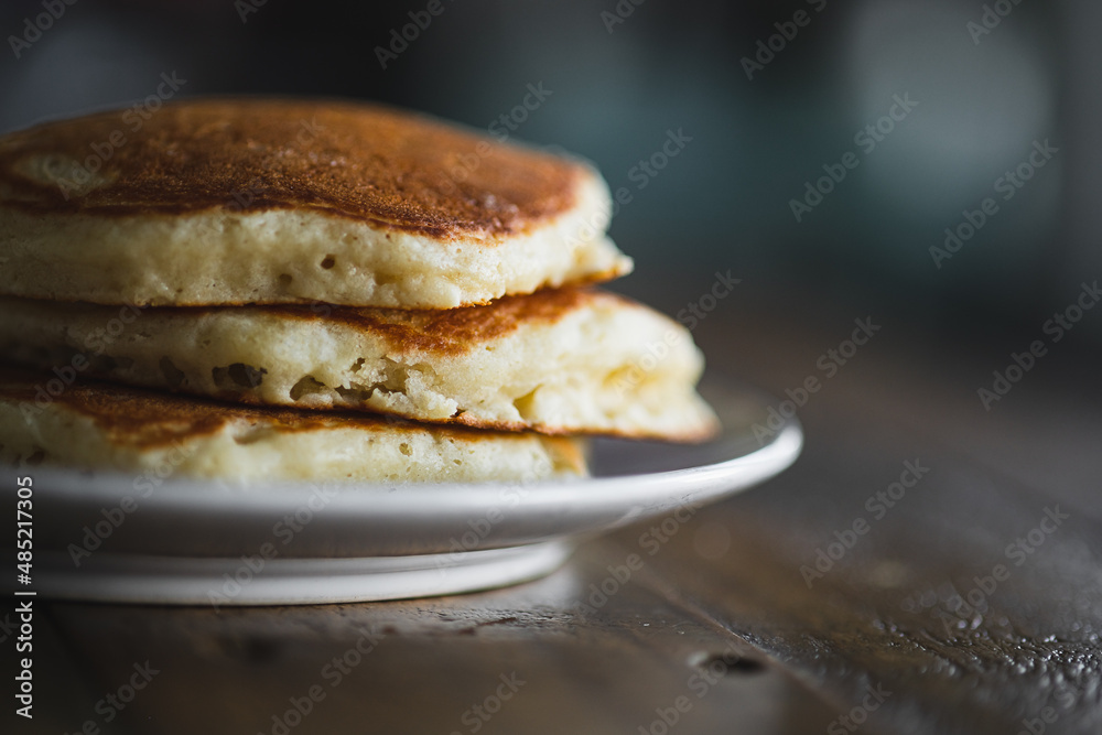 Short Stack of Pancakes on Wooden Table in Morning Light. Cooking Breakfast Lifestyle. Short Stack of Pancakes on Wooden Table in Morning Light. Cooking Breakfast Lifestyle.
