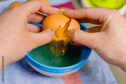 hands cracking an egg for some kind of recipes