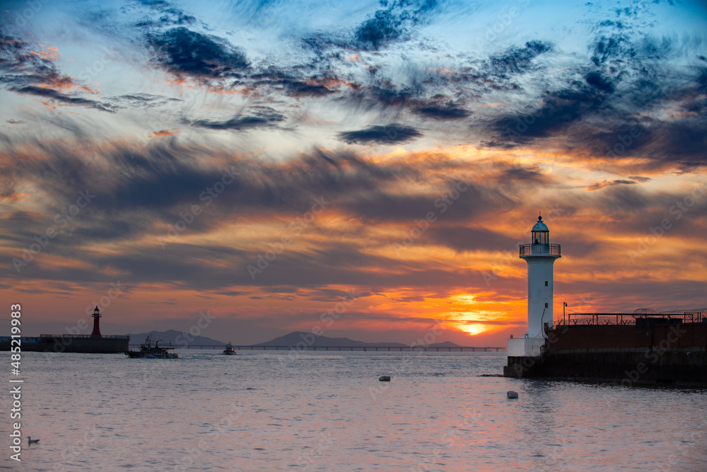 Evening view of the seaside with a view of the lighthouse
