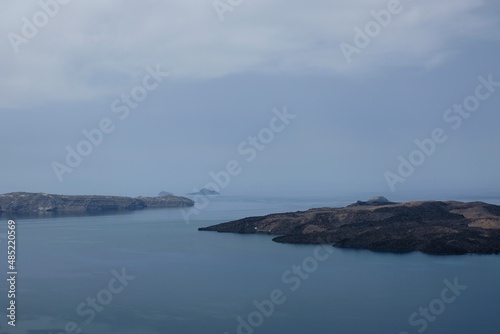 Panoramic view of the volcano Nea Kameni and the Aegean Sea in Santorini Greece