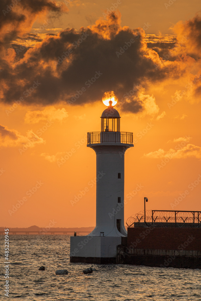 Seaside landscape with sunset and lighthouse
