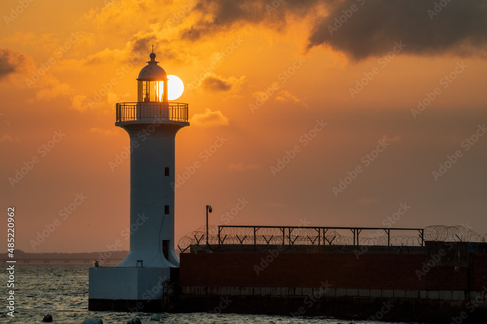 Sunset on the beach with a lighthouse view

