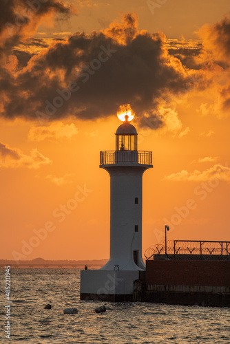 Seaside landscape with sunset and lighthouse 