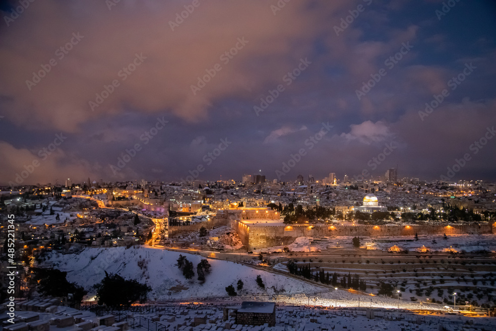 view of jerusalem and dome of the rock with snow from the mt of olives