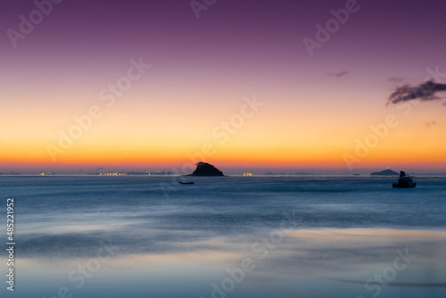 Dawn of an island resembling a shark s fin 