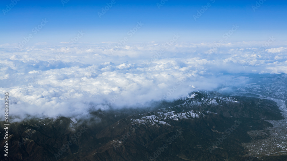 Wonderful landscape with japanese summit mountains above dense low clouds. Japan
