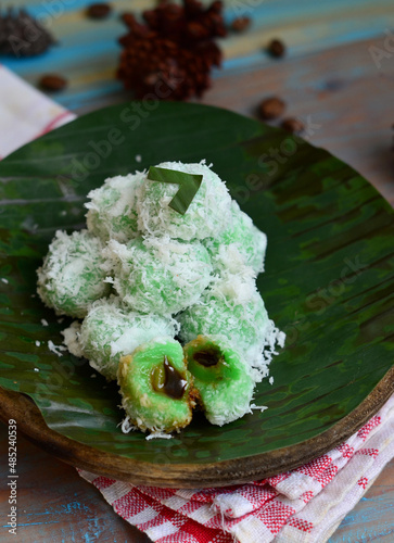 kelepon or klepon or onde-onde made from glutinous rice flour and filled with brownn sugar covered with grated coconut. Some people called this traditional cake from Indonesia as Onde-onde. photo