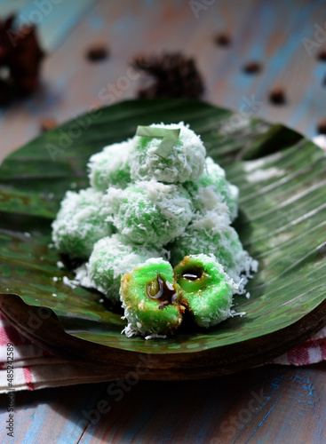 kelepon or klepon or onde-onde made from glutinous rice flour and filled with brownn sugar covered with grated coconut. Some people called this traditional cake from Indonesia as Onde-onde photo