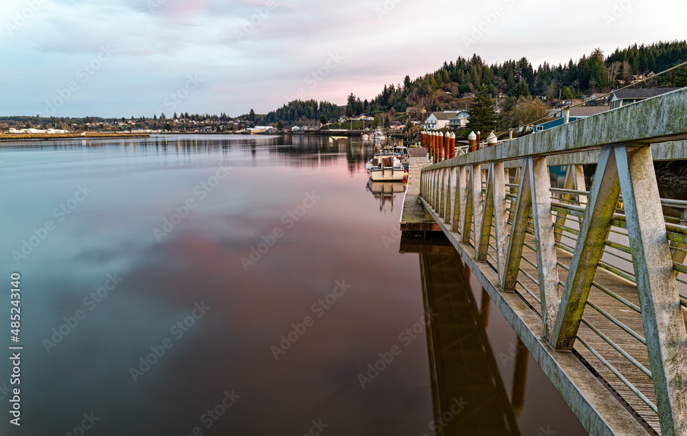 Fototapeta premium Boat dock at sundown on the Willapa River at South Bend in Washington, USA