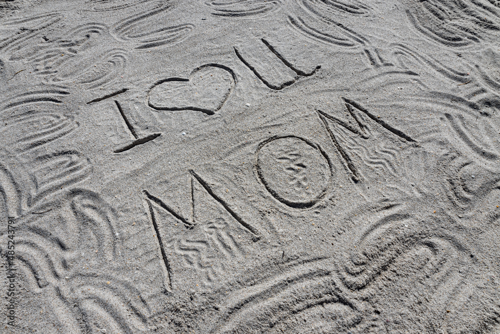 The inscription on the sand. I love you mom.
