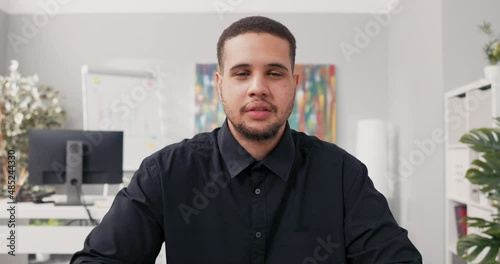Wallpaper Mural Serious man well-groomed elegant dressed in black shirt sits at desk in front of computer internet conversation business training, live conference Torontodigital.ca
