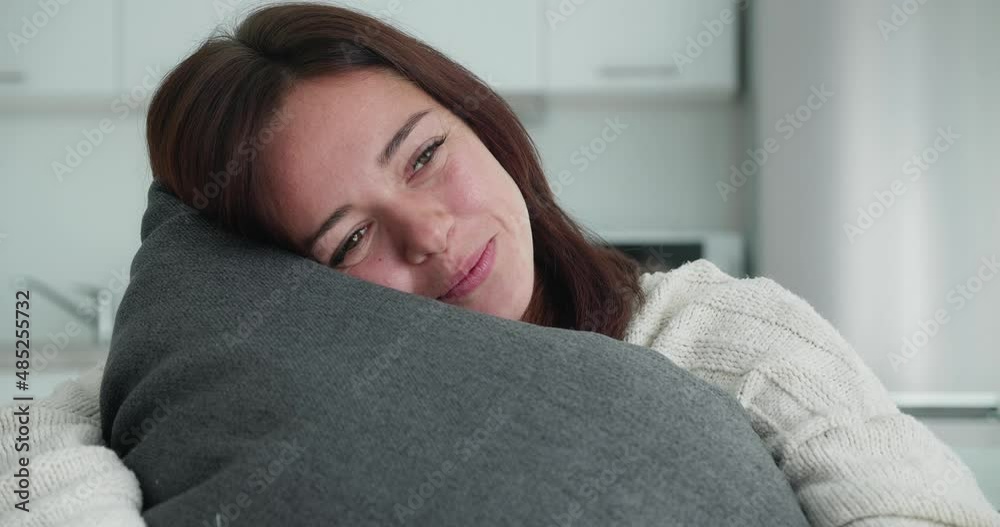 Beautiful smillimg women hugging her pillow. Concept of dreaming, carelessness, appeasement Beautiful smillimg women hugging her pillow. Concept of dreaming, carelessness, appeasement