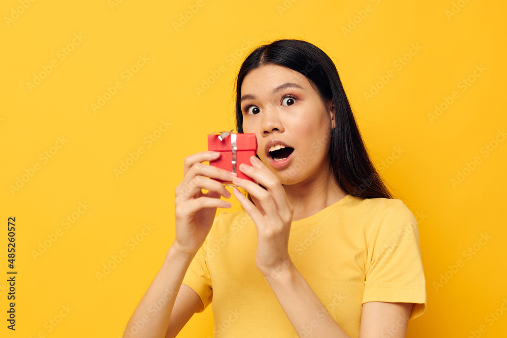 Charming young Asian woman Little red gift box fun isolated background unaltered Charming young Asian woman Little red gift box fun isolated background unaltered