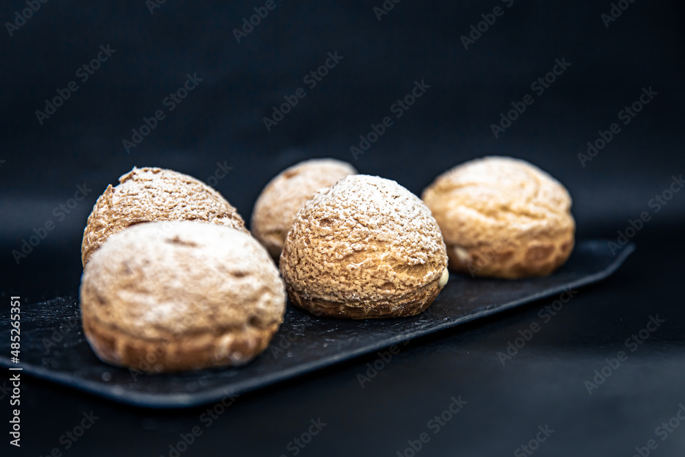 Appetizing Shu cakes on a black background. Appetizing Shu cakes on a black background.
