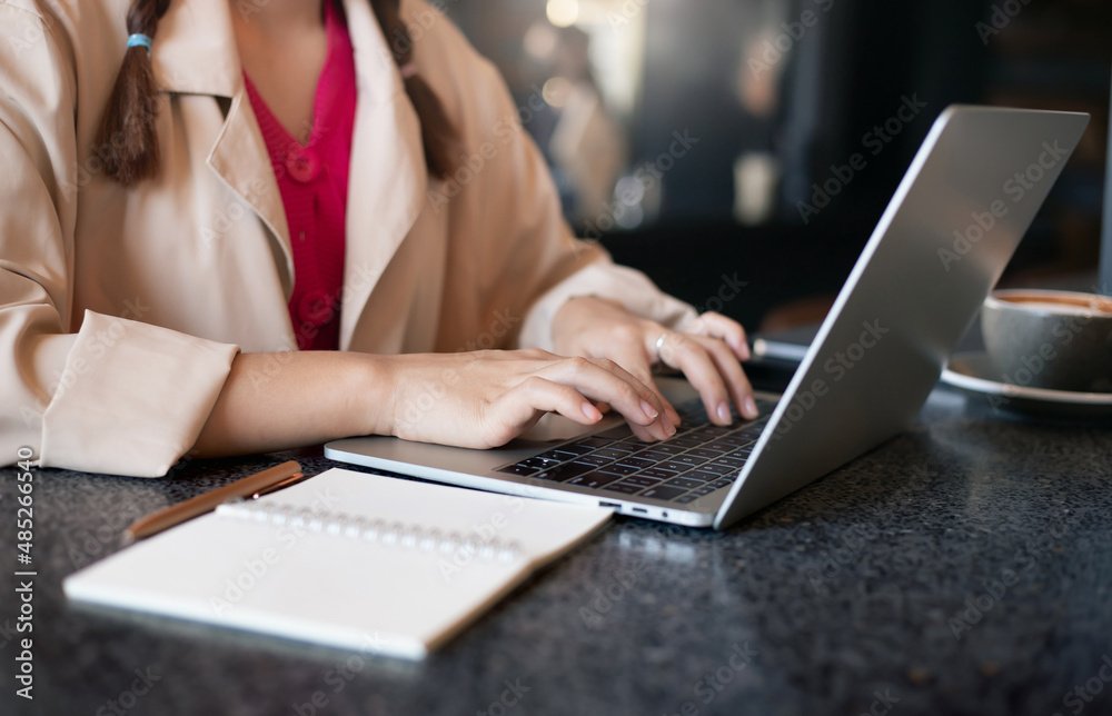 Young asian woman in casual cloth using laptop computer working or study online. Closeup photo and select focus on hand