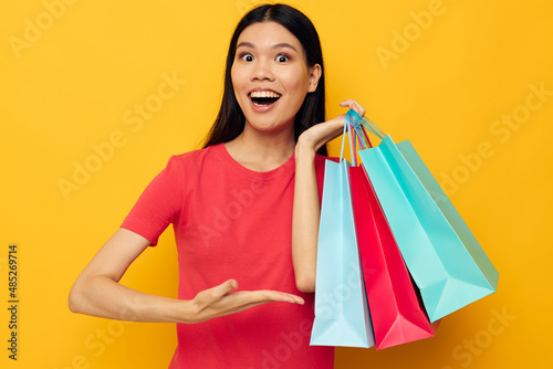 Charming young Asian woman with colorful bags posing shopping fun Lifestyle unaltered