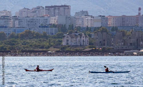 Beautiful kayaks on the background of the embankment in the bay of the city of Novorossiysk in summer