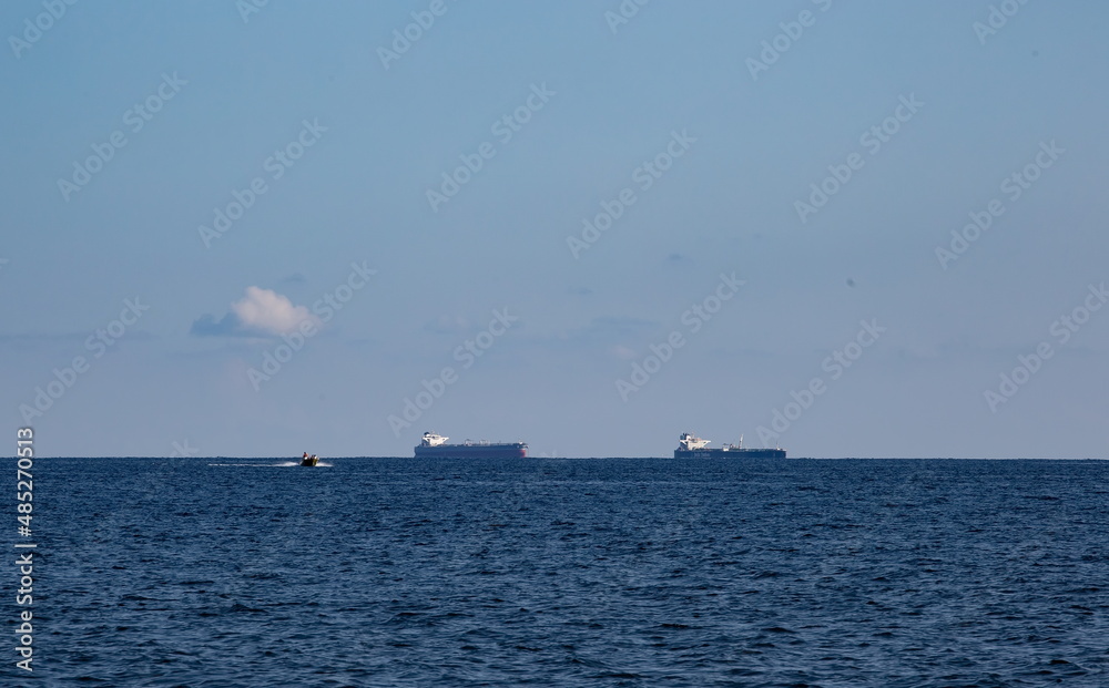 merchant ships on the roadstead in the bay of the city of Novorossiysk on a clear sunny day in summer