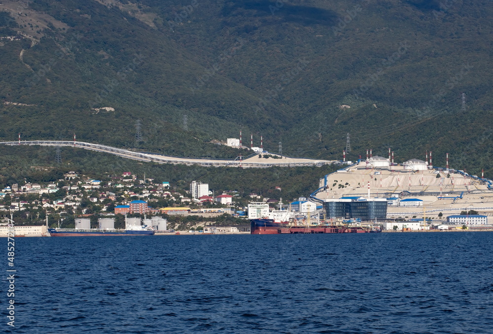 Mountains for cement extraction in the bay of the city of Novorossiysk on a clear day in summer
