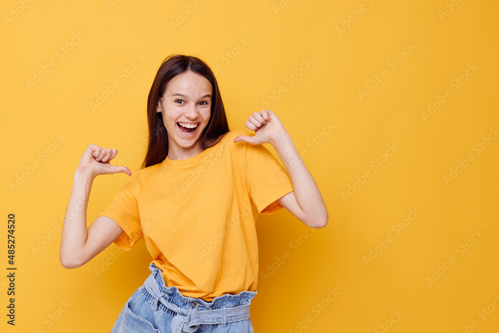 young woman in a yellow t-shirt emotions summer style isolated background young woman in a yellow t-shirt emotions summer style isolated background