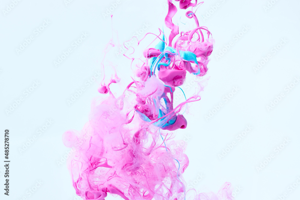 Abstract bright pink and blue ink splash background over gray