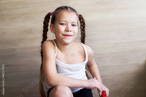 Konstfotografi girl child with pigtails posing and showing off the length of her beautiful hair