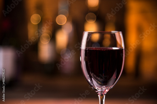 closeup photo of red wine glass on bar counter background