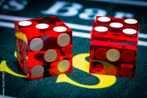 Картината върху платно A macro photograph of professional casino-style dice sitting on the pass section of a craps table