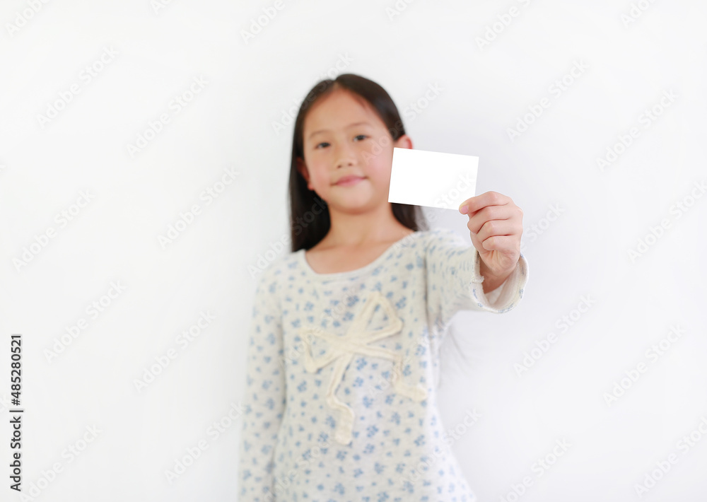 Asian girl kid showing blank white card over white background. Focus at card in child hand. Asian girl kid showing blank white card over white background. Focus at card in child hand.