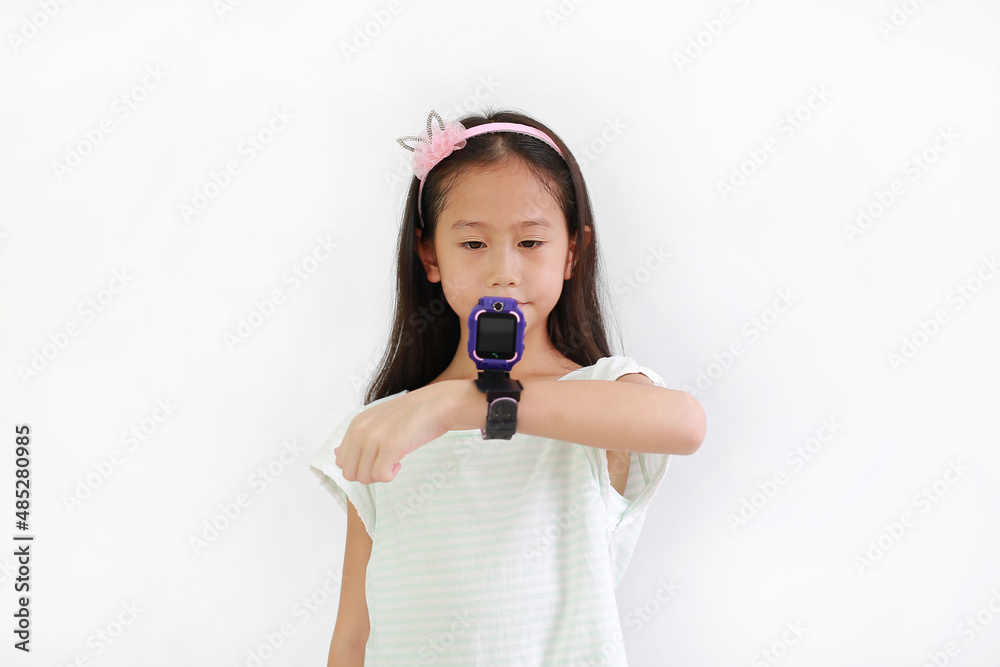 Asian little girl kid using smart watch video camera against white background. Focus at child face. Asian little girl kid using smart watch video camera against white background. Focus at child face.