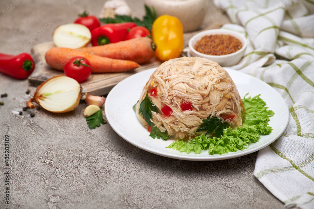 Delicious chicken aspic on a plate on concrete table