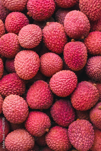 a lot of ripe juicy red lychee close up