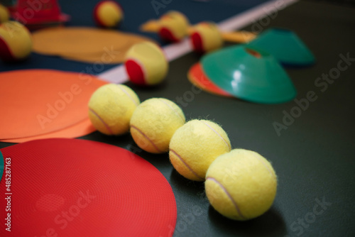 A set of training equipment for playing tennis. Tennis balls on an indoor court