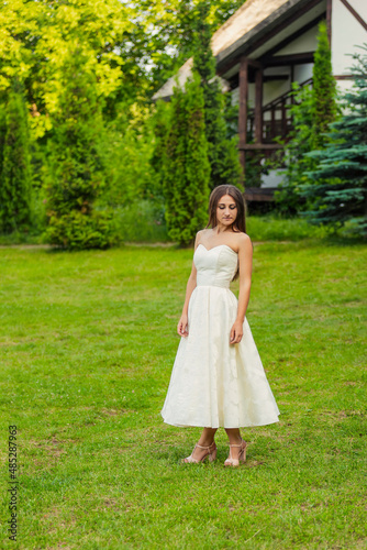 woman in a white dress on a green lawn