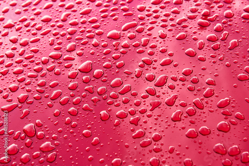 Water drops on red color background