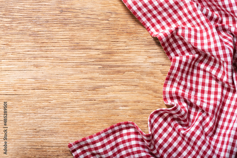 red checkered tablecloth on wooden background red checkered tablecloth on wooden background