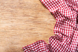 red checkered tablecloth on wooden background