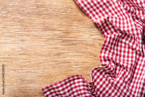 red checkered tablecloth on wooden background