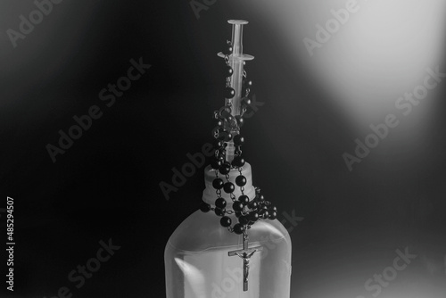 Rosery with a cross on a syringe