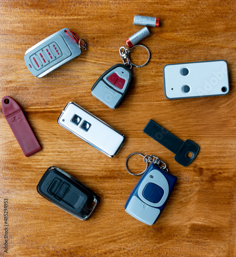 remote controls for garage doors on wooden background