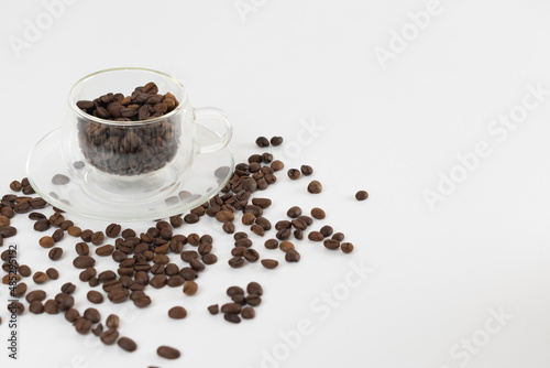 Coffee beans on a white background. Cup of coffee beans.