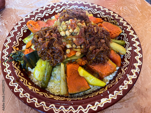 Delicious Friday couscous with sweet rasins on top of it with sugar and onion photo